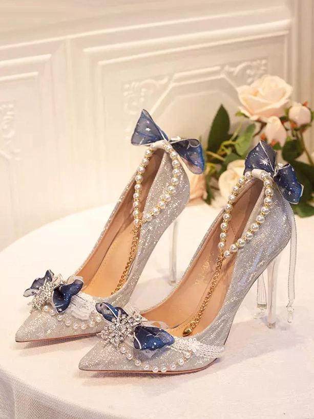 Overhead three-quarter view dark blue tulle bow pearl ankle chain crystal drop decor silver glitter upper bridal stiletto heels