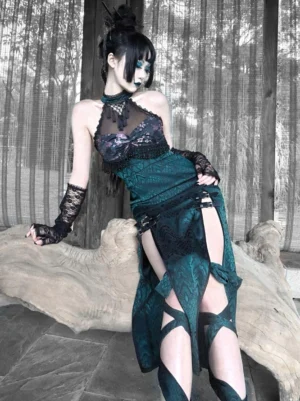 Dark green gothic lolita jsk jumper skirt with fringe beaded bust and floral print, three-quarter side view showing high side splits with strap fasteners and lace embellishments