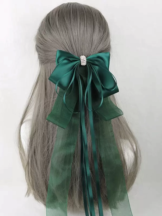 Dark green satin bow hair accessory with rhinestone embellishment and mixed long ribbon streamers, sweet lolita headdress back view on mannequin