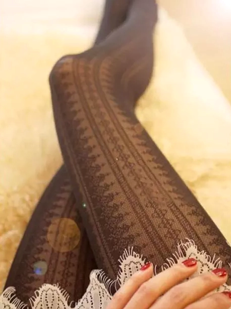 dark jacquard lolita tights crossed legs pose showing vintage floral pattern lace trim sheer silk material with red nail polish
