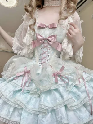 Close-up upper front view of mint green Lolita dress featuring sheer lace sleeves pink ribbon bows and intricate lace-up corset bodice detail