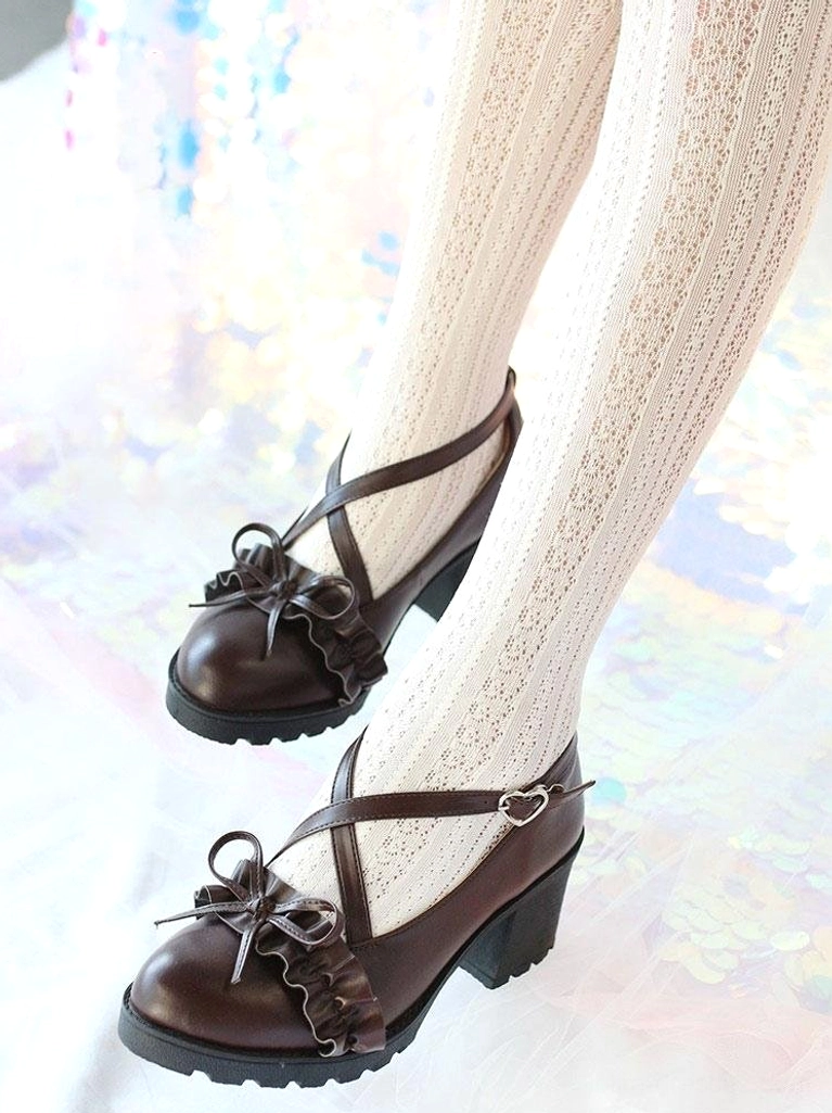Deep brown Lolita pumps side view of wearing feet, model in textured white tights, iridescent shiny background highlighting chunky outsole and round block heel design