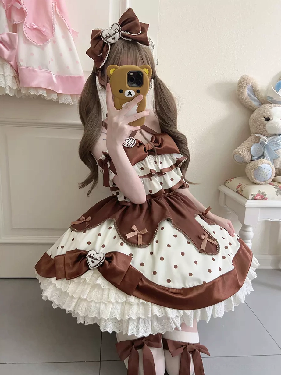 Deep brown and white polka dot sweet lolita jumper dress with heart-shaped brooch, lace skirt trim, modeled with brown bow headwear and twin tails