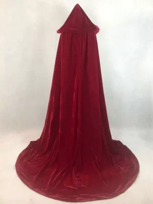 Deep red solid velvet hooded cape with smooth finish and floor-length train on plain studio background, front static view - gothic lolita cloak design