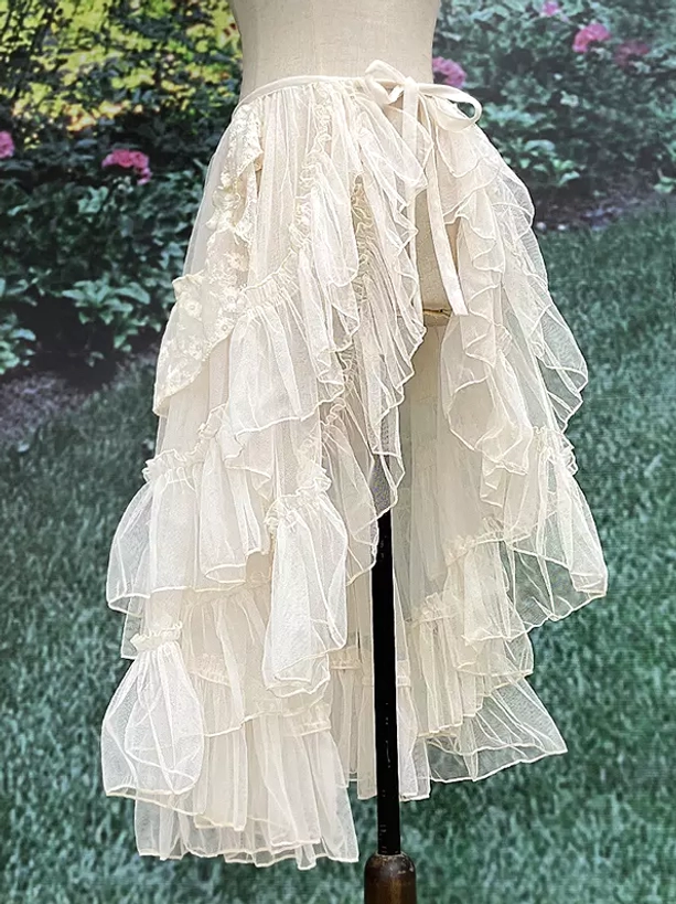 Lolita sweep train overskirt with asymmetrical ruffled tulle tiers and tie-waist detail photographed from side full view