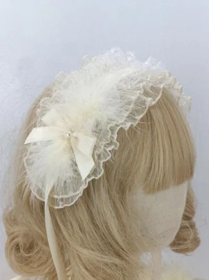 Ecru white feathered Lolita headdress with satin bow and pearl accents worn on blonde bob wig mannequin, showing side profile view of complete sweet Lolita hairband design with ruffled lace trim and delicate embellishments