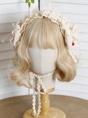 Front view of sweet lolita headdress accessory featuring ecru hollow lace ruffles, side strawberry charms, and long ribbon neck tie on styled mannequin with blonde curly wig
