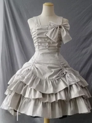 Ecru white gothic lolita JSK dress front view showing ruched bodice with square neckline and asymmetric multi-layer ruffled skirt with side bow