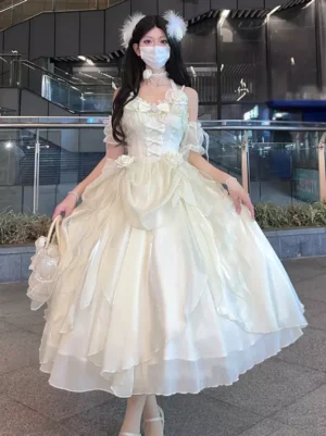 Ecru white frilly sweet lolita dress with off-shoulder bandage straps and feather hair accessory vintage aesthetic front view model street