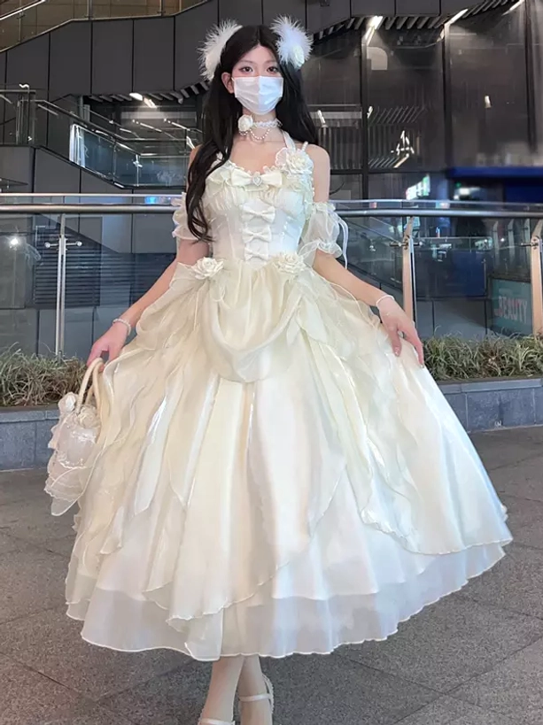 Ecru white frilly sweet lolita dress with off-shoulder bandage straps and feather hair accessory vintage aesthetic front view model street