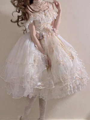 Ecru white off-the-shoulder Hime Lolita wedding dress rear view, showing voluminous layered tulle skirt with delicate floral embroidery and ruffled details on model with brown curly hair
