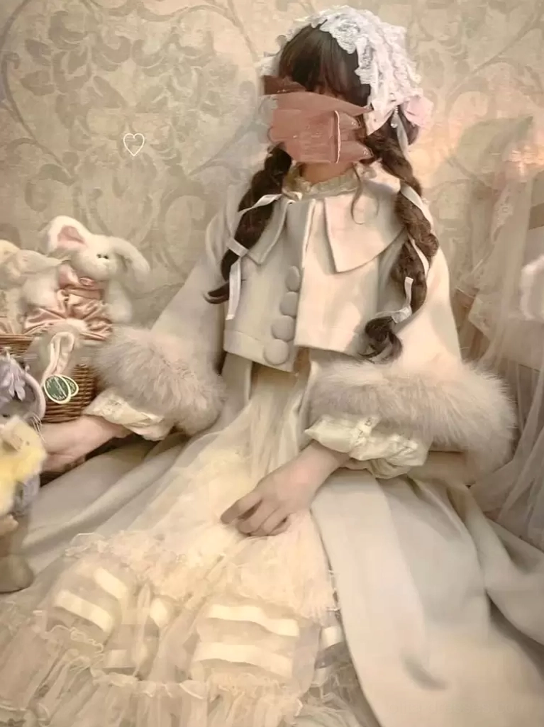 Side sitting view of ecru white sweet lolita wool overcoat with fluffy white fur cuffs, masked lolita model in vintage decorative scene, matching beige handbag accessory, demonstrating how coat drapes during seated positions