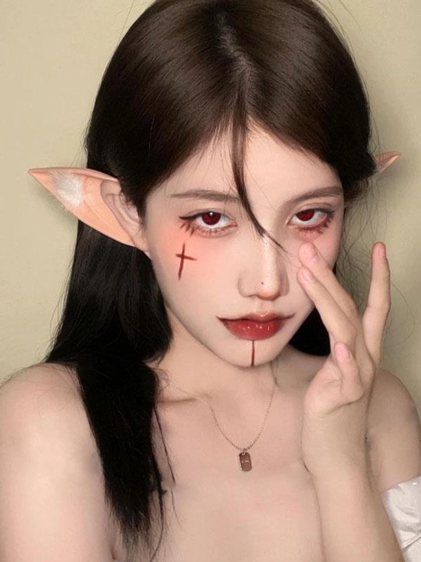 Three-quarter side portrait of elf ear accessory paired with metal pendant necklace, demonstrating styling versatility for sweet lolita and gothic lolita fashion coordinates