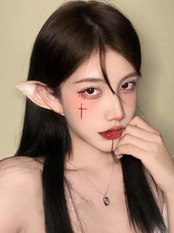 Side frontal close-up portrait of delicate elf ear cosplay prop with fuzzy white decorations and simple metal pendant, perfect for lolita tea party and fantasy costume events
