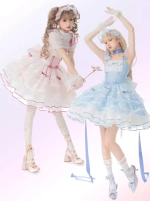 Two enchanted sweet Lolita jsk dresses in pink-white and black-white color options displayed on mannequins against gradient pastel backdrop, showcasing ruffled tiered skirts and ribbon sashes - fairy Lolita fashion