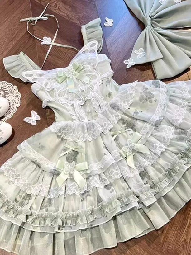 Green fairy JSK dress detachable components flat lay showing bows butterfly appliques lace trims matching fabric