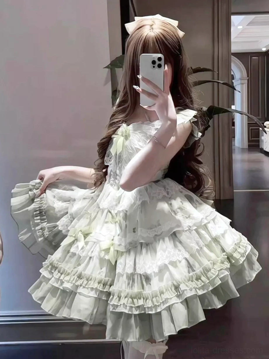 Girl wearing green and white fairy JSK dress with tiered ruffles and lace trims indoor mirror selfie