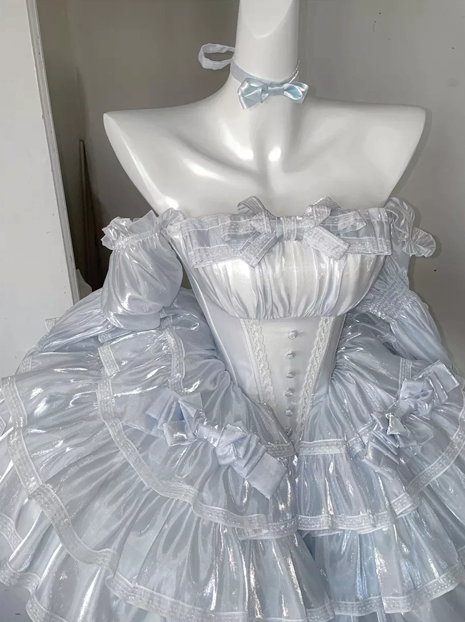 Fairy lolita dress styling details close-up showcasing premium lace overlays, decorative bow embellishments, tiered ruffle construction, and shiny polyester fabric