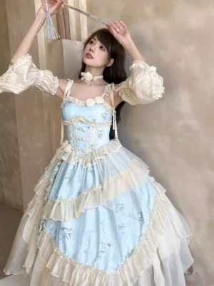 Sweet lolita princess dress half front view featuring light blue fabric with subtle floral print, cream ruffle trims, matching flower choker necklace, and tassel hand fan accessory displayed on elegant background