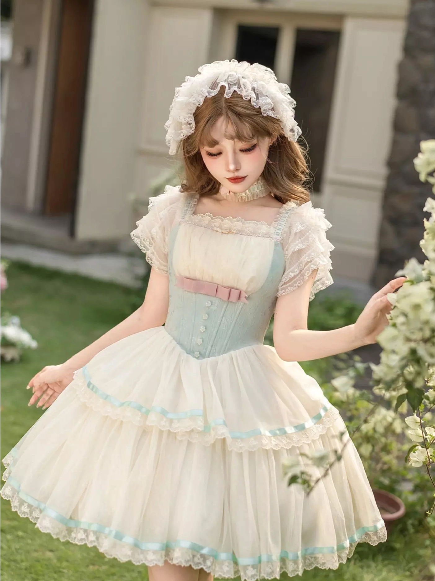 Fairy lolita dress three-quarter view square off-shoulder neckline matching lace hair bonnet outdoor garden residential setting