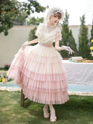 Pastel ombre lolita dress rear back view outdoor lawn holding skirt hem with pink shoes and socks