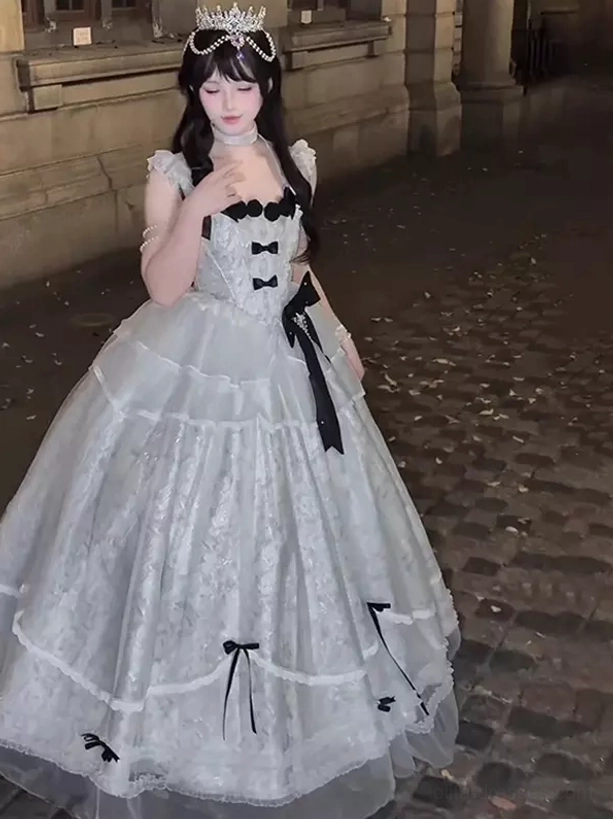 Blue gray fairytale lolita ball gown front view outdoor vintage setting female model crown square ruffled neckline black bows