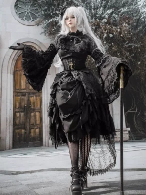 Three-quarter side view of black gothic lolita dress ensemble showing structured corset waist, dramatic lace bell sleeves, and ruffled skirt silhouette, model holding ornate walking cane