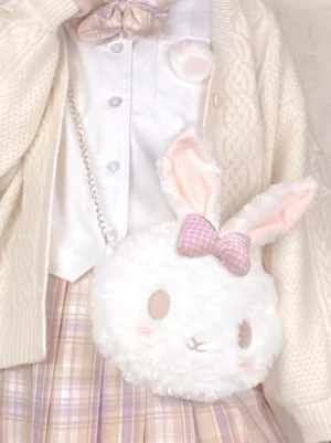 Fluffy white bunny crossbody bag styled with cream knit cardigan and plaid skirt outfit featuring pink gingham bow and metal chain pearl strap lolita coordinate