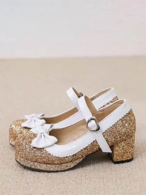 Gold glitter Lolita Mary Jane heels showing white trim white bow decoration and heart-shaped strap buckle detail oblique flat lay