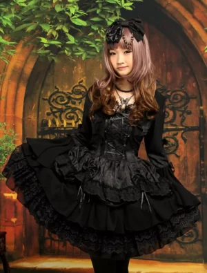 Gothic black lolita one-piece dress front three-quarter view with layered lace skirt and lace-up corset waist, featuring long hime sleeves and square neckline