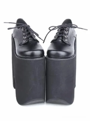 Pair of black Gothic Lolita platform lace-up shoes with sky-high wedge heel, front paired display view showing shiny smooth PU leather upper and thick matte platform sole with metal lace eyelets
