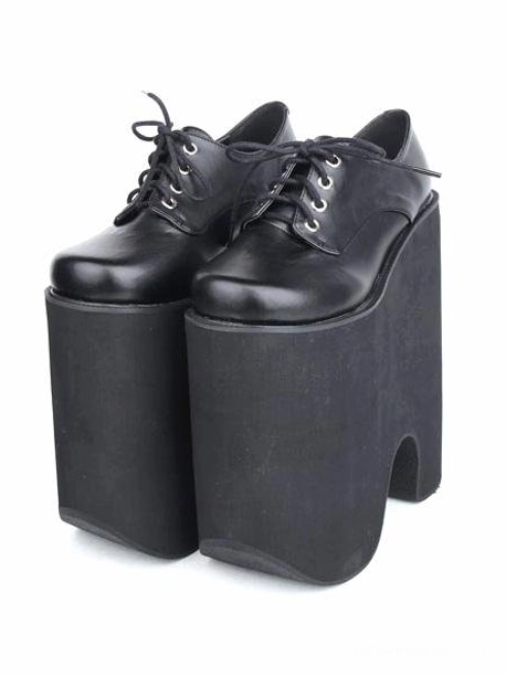 Pair of black Gothic Lolita platform lace-up shoes, side paired display view revealing thick matte platform sole, metal lace eyelets detail, and clean smooth leather finish