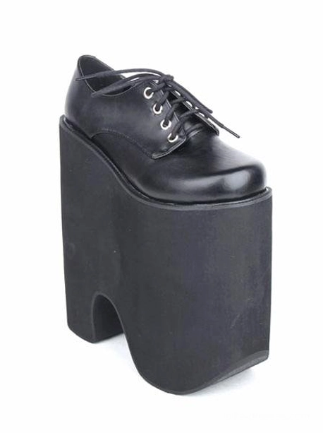 Single black Gothic Lolita platform lace-up shoe, three-quarter rear view displaying cut-out block platform heel, shiny leather vamp, and matte black textured sole finish