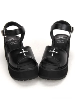 Gothic black lolita platform sandals front view featuring white cross embroidery, peep toe design, and adjustable ankle buckle strap on pure white background