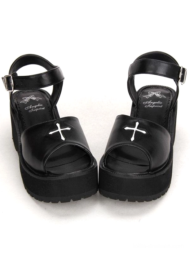 Gothic black lolita platform sandals front view featuring white cross embroidery, peep toe design, and adjustable ankle buckle strap on pure white background