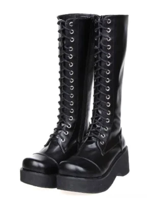 Gothic black platform knee-high lolita boots front three-quarter pair view with polished leather and metal lace eyelets on white background
