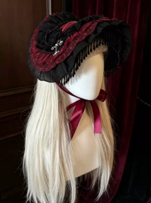 Dark Gothic Lolita lace fascinator headdress right side profile view on mannequin showcasing beaded fringe details, cross charm, black and burgundy color scheme with ruffled lace trim against vintage wood panel and velvet backdrop