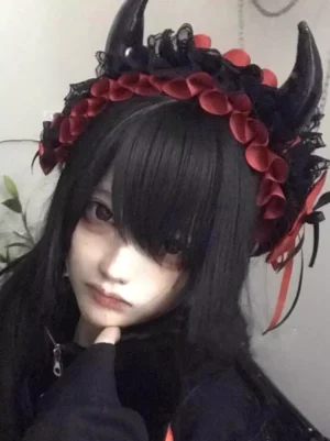 Gothic devil horns lolita hair headpiece black red with lace petal trim close-up front view on model
