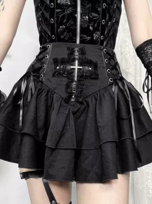 Black gothic high waist mini skirt with cross decor waistband and tiered ruffle hem front view close-up