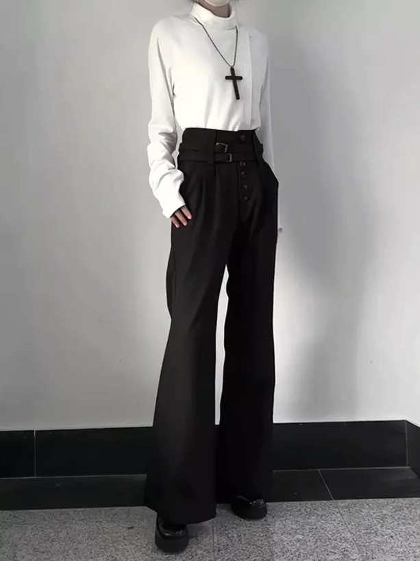 Gothic high-waisted black flare trousers front full-body view demonstrating structured silhouette and wide leg drape, coordinated with white turtleneck and cross pendant for elegant contrast
