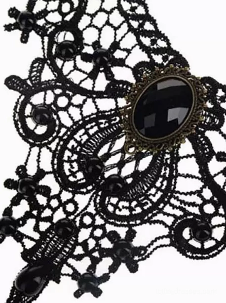 Close-up top-down detail of Gothic choker floral lace pattern intricate black beads bronze-rimmed gemstone