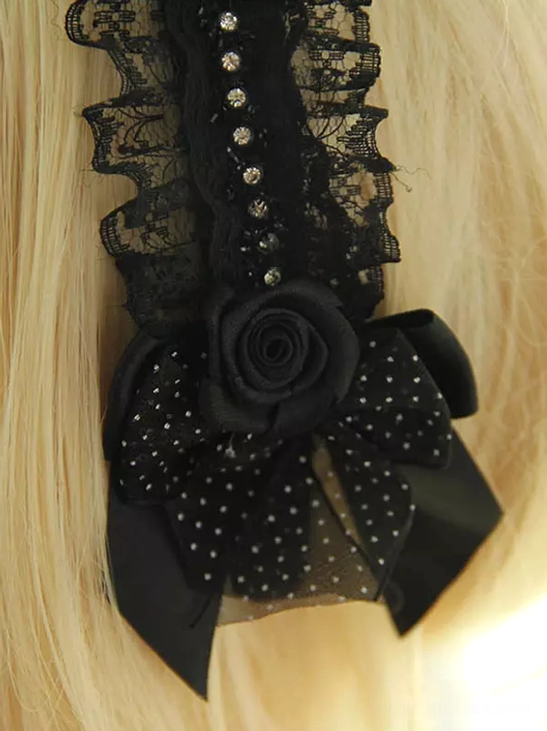Close-up detail shot lolita hair accessory lower section polka dot black bow fabric rose decoration inlaid round rhinestones black lace embellishments