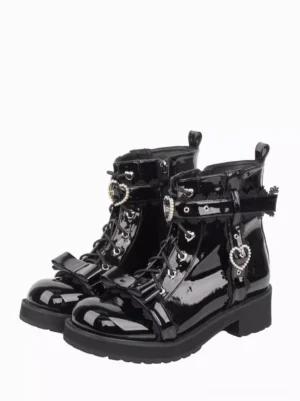 Black patent leather Gothic Lolita ankle boots with bow straps and heart rhinestone charms front three-quarter view