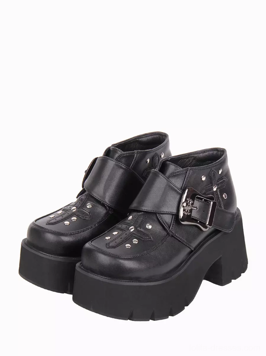 Gothic lolita ankle boots with black PU leather and cross rivet embellishments, front three-quarter view showing chunky block heel and skull-shaped metal buckle strap