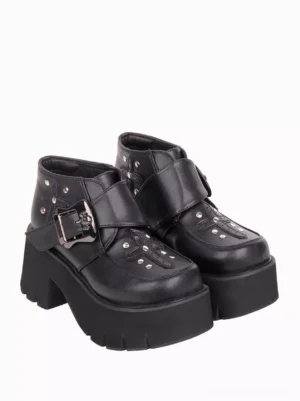Side view of gothic lolita ankle boots displaying skull belt buckle, metal studs, and thick platform sole with jagged edge detailing