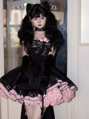 Full front view of black gothic lolita dress with pink ruffled skirt hem and lace-up corset on model