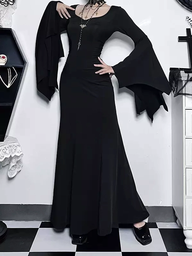 Black gothic evening gown with bat-shaped flared sleeves and floor-length mermaid skirt, three-quarter side view showing fitted waist and elegant draping