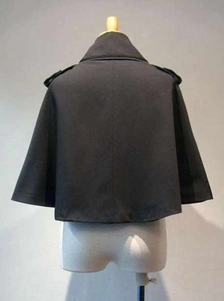 Black Gothic Lolita cropped cape rear back view displaying plain solid back design, shoulder epaulets with buttons, short cape length, and overall tailored structure on dress form