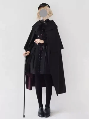 Gothic lolita black cape coat with wine-red lining worn by model with walking cane full front view sleeveless poncho