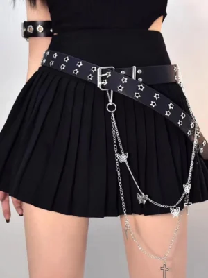 Gothic lolita black leather chain sash belt with hollow star studs and layered silver chains featuring butterfly and cross pendants worn on black pleated skirt back three-quarter view